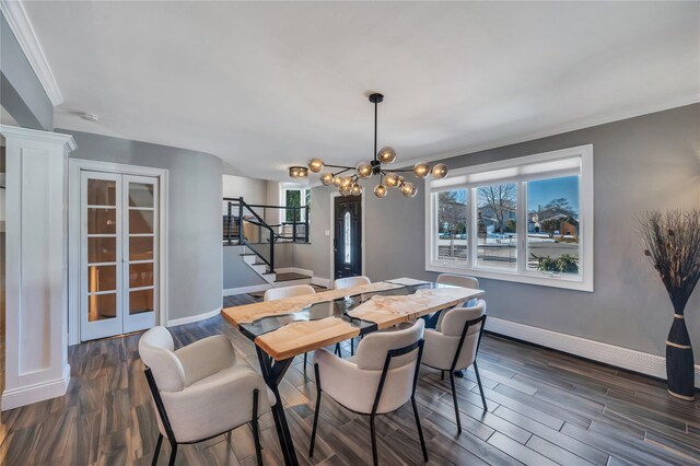 dining space featuring dark wood finished floors, baseboards, stairs, and a notable chandelier
