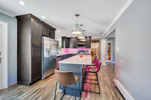 kitchen with recessed lighting, appliances with stainless steel finishes, ornamental molding, and a baseboard radiator