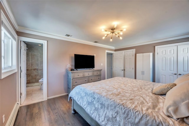 bedroom featuring visible vents, baseboards, a baseboard heating unit, two closets, and dark wood-style floors