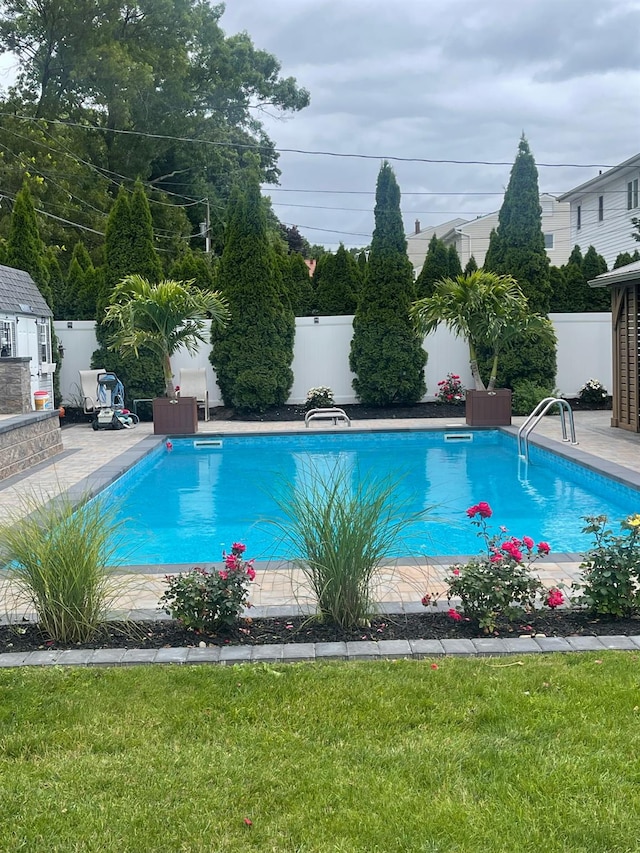 view of pool with a fenced in pool, a fenced backyard, and a lawn