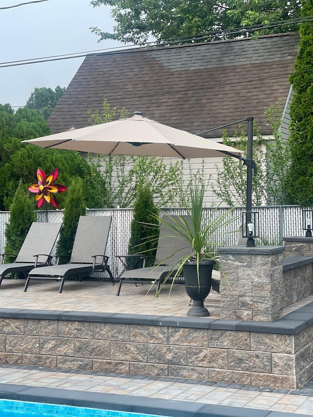 view of swimming pool featuring fence