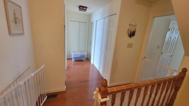 hallway with baseboards and wood finished floors