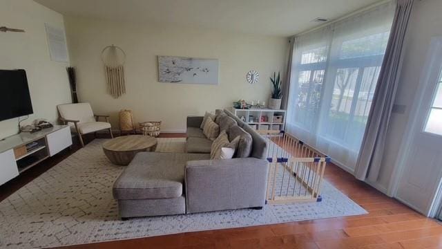 living area featuring a wealth of natural light and wood finished floors