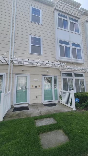 rear view of house featuring a lawn