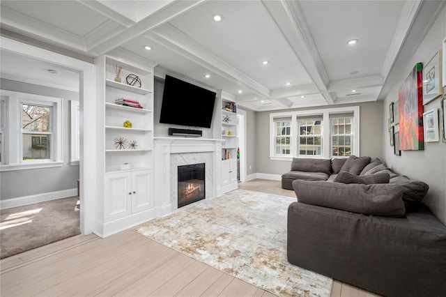 living area featuring crown molding, plenty of natural light, and light wood-style flooring