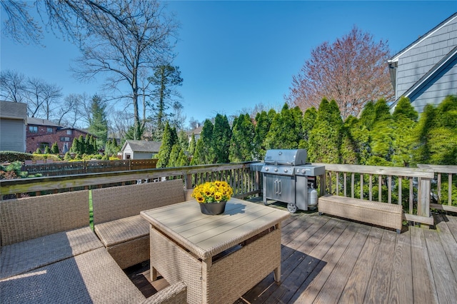 wooden terrace featuring outdoor dining area and a grill
