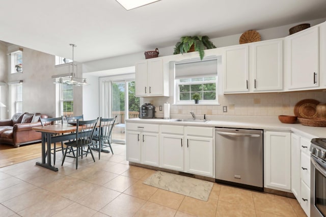 36 Alexander Dr, Washingtonville, NY 10992 - kitchen featuring stainless steel appliances, a sink, backsplash, light countertops, and white cabinetry