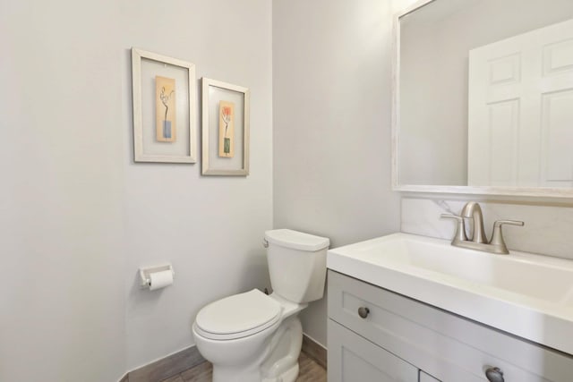 36 Alexander Dr, Washingtonville, NY 10992 - half bathroom featuring toilet, baseboards, vanity, and wood finished floors