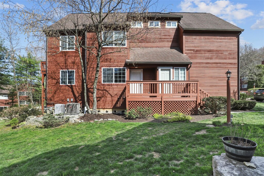 203 Apple Tree Ln, Brewster, NY 10509 - back of house with a deck, a yard, a shingled roof, and central AC