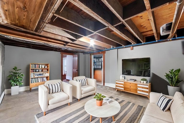 living room with concrete floors and baseboards