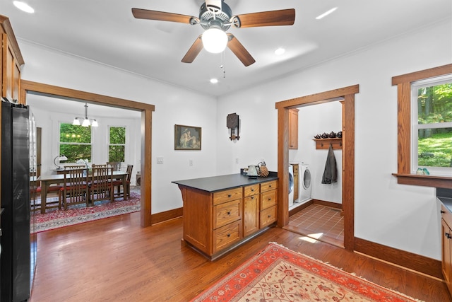 101 Mohican Park Ave, Dobbs Ferry, NY 10522 - kitchen featuring dark wood-type flooring, freestanding refrigerator, independent washer and dryer, baseboards, and dark countertops