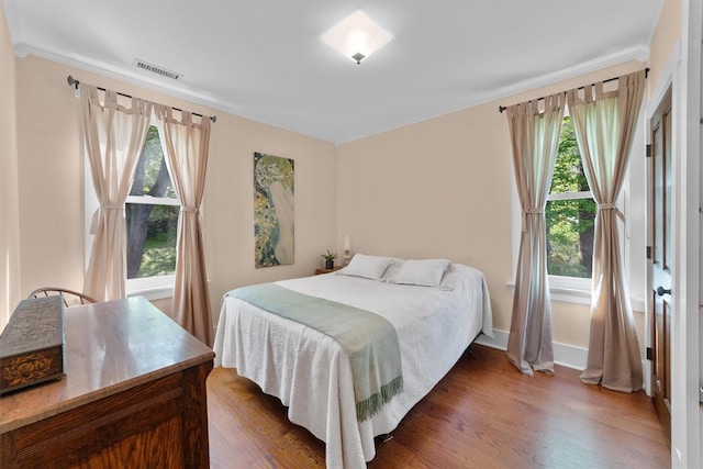 101 Mohican Park Ave, Dobbs Ferry, NY 10522 - bedroom featuring wood finished floors, multiple windows, baseboards, and crown molding