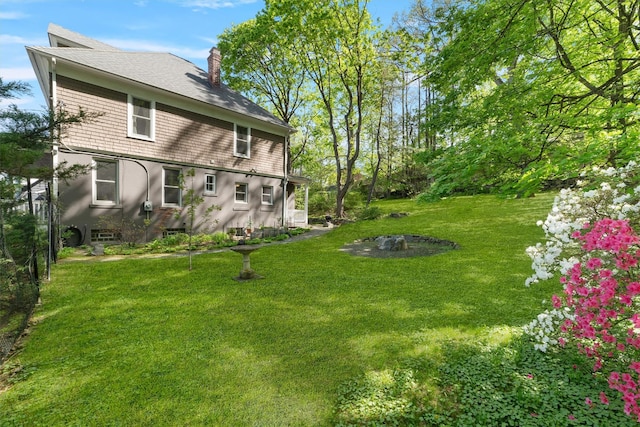 101 Mohican Park Ave, Dobbs Ferry, NY 10522 - rear view of property with stucco siding, a lawn, a chimney, and roof with shingles