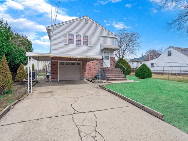 tri-level home featuring brick siding, fence, driveway, and a front yard