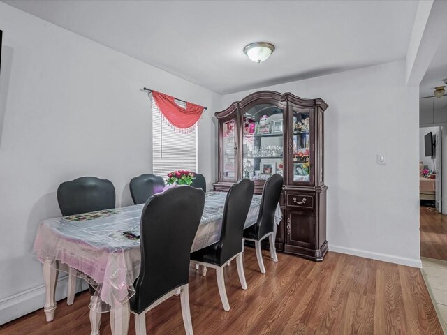 dining space with wood finished floors and baseboards