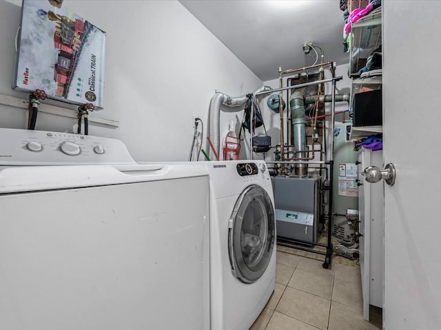washroom featuring gas water heater, a heating unit, tile patterned floors, and laundry area