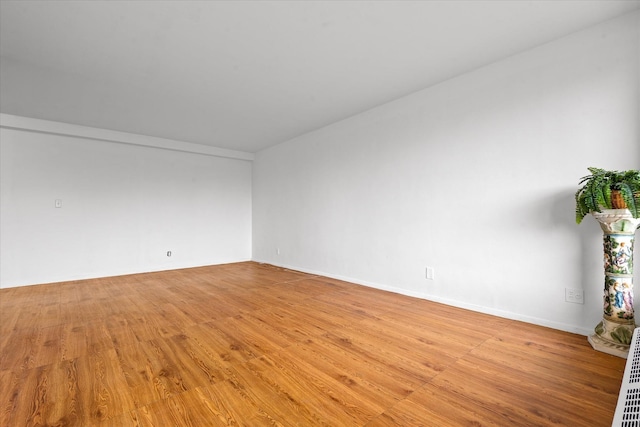unfurnished room featuring light wood-style flooring and baseboards