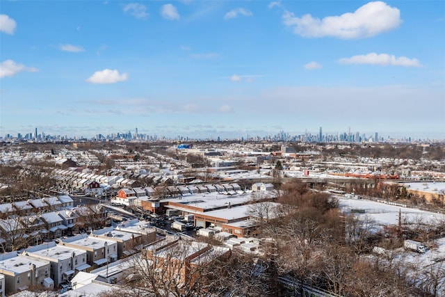 snowy aerial view with a city view