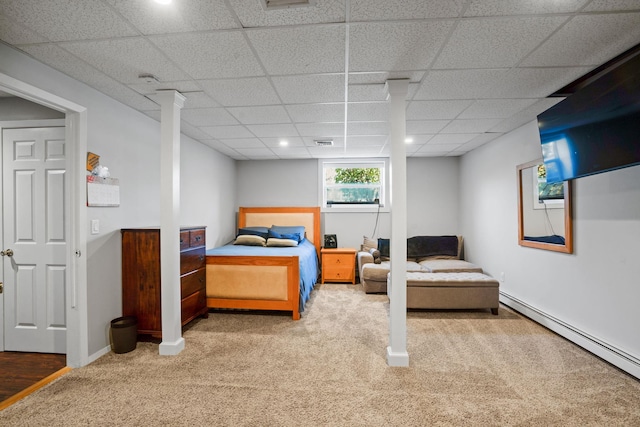 carpeted bedroom with baseboards, visible vents, a drop ceiling, and baseboard heating