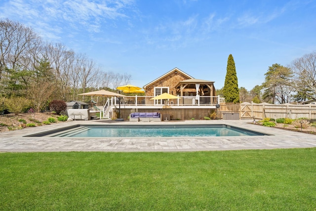 pool with a lawn, a wooden deck, a gazebo, and outdoor lounge area