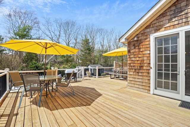 wooden terrace with outdoor dining area