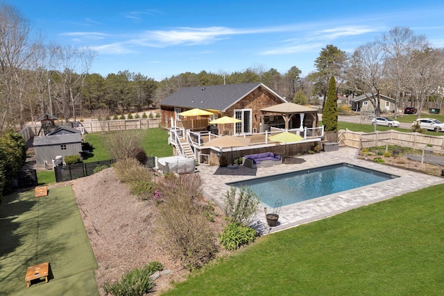view of pool featuring a gazebo, a fenced backyard, a fenced in pool, a patio, and a yard