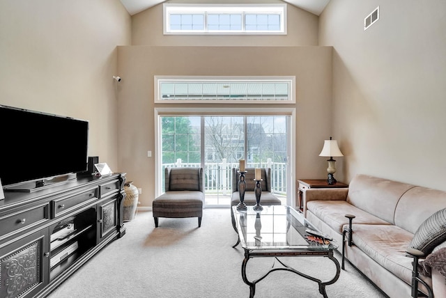 10 Symphony Dr, Lake Grove, NY 11755 - carpeted living area with visible vents, high vaulted ceiling, and plenty of natural light