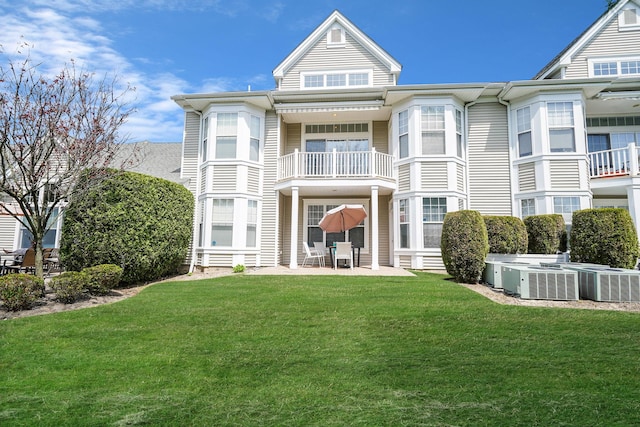 10 Symphony Dr, Lake Grove, NY 11755 - rear view of property featuring a lawn, central AC unit, a balcony, and a patio