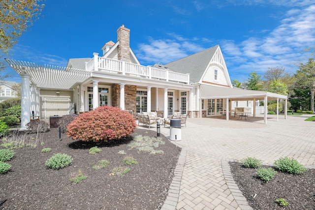 10 Symphony Dr, Lake Grove, NY 11755 - back of property with a pergola, a patio, stone siding, a chimney, and french doors
