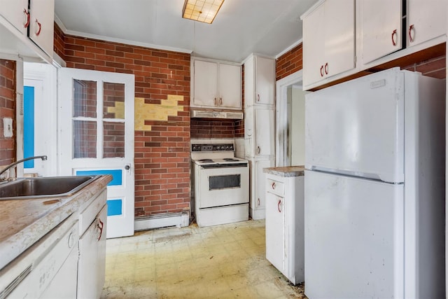 kitchen with a sink, a baseboard heating unit, white appliances, light floors, and brick wall