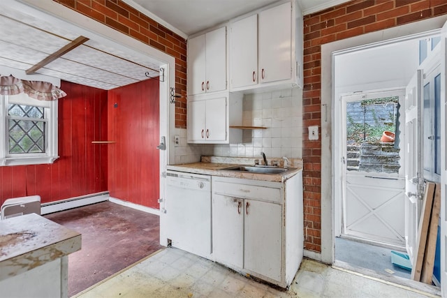 kitchen with dishwasher, a sink, baseboard heating, and plenty of natural light