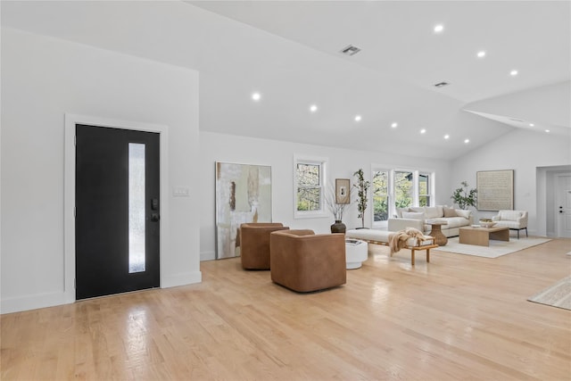 living room with recessed lighting, high vaulted ceiling, visible vents, and light wood-style floors