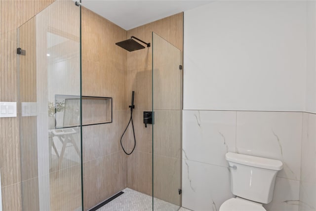 bathroom with walk in shower, toilet, and tile walls