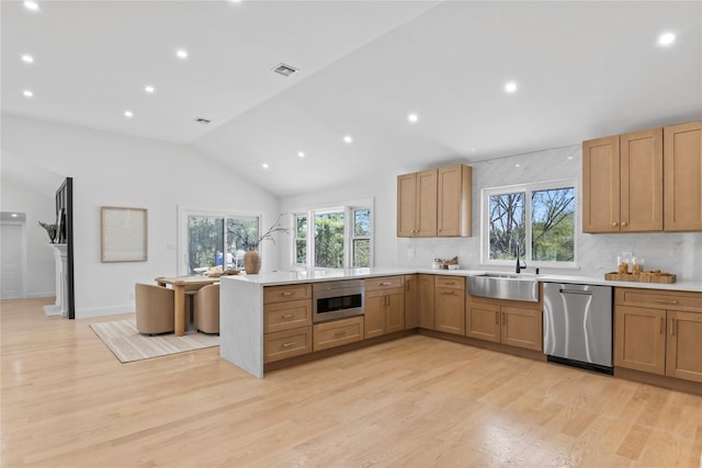 kitchen with stainless steel dishwasher, visible vents, a peninsula, light countertops, and built in microwave