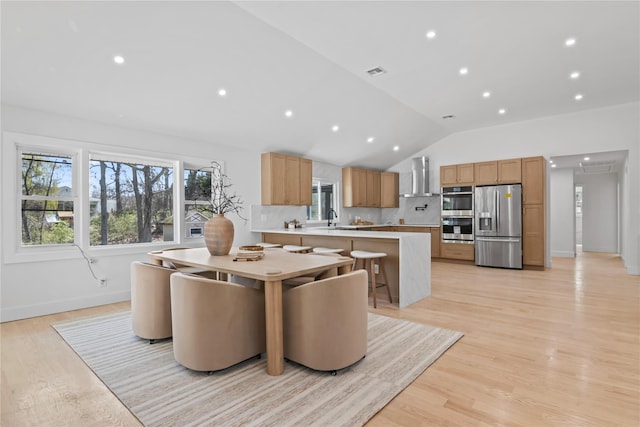 dining space featuring visible vents, light wood-style flooring, recessed lighting, baseboards, and vaulted ceiling
