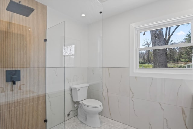 bathroom featuring a walk in shower, tile walls, tile patterned flooring, and toilet