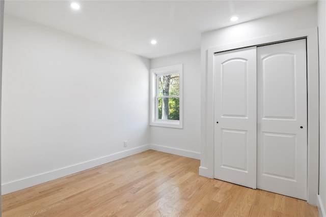 unfurnished bedroom featuring recessed lighting, baseboards, and light wood-type flooring