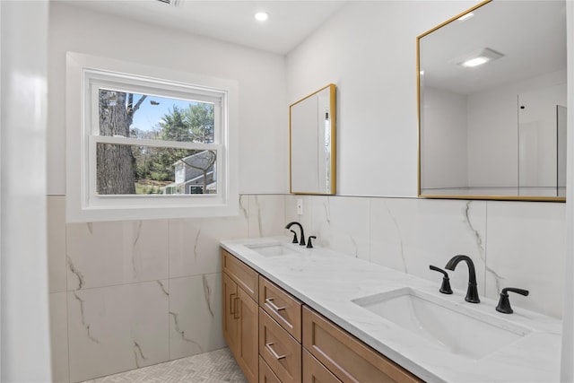 7 Breezy Hill Dr, Northport, NY 11768 - full bath featuring a sink, tile walls, and double vanity