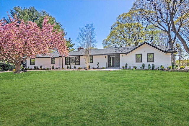 7 Breezy Hill Dr, Northport, NY 11768 - rear view of property featuring roof with shingles, a yard, and a chimney