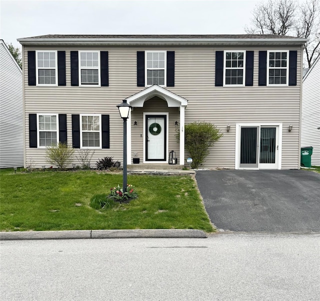 colonial inspired home with a front yard