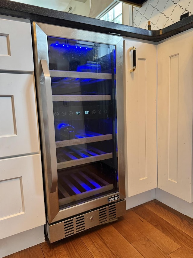 room details with beverage cooler and wood finished floors