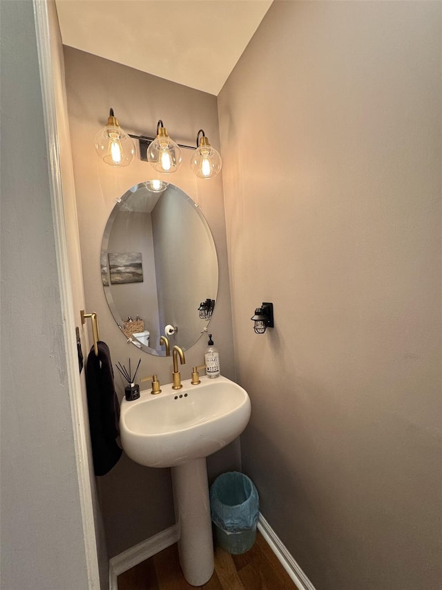 bathroom with wood finished floors and baseboards