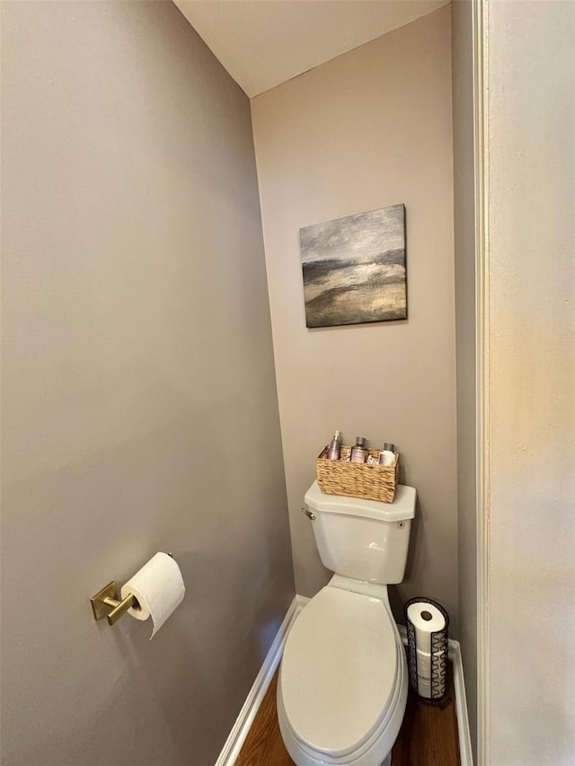 bathroom with toilet and baseboards