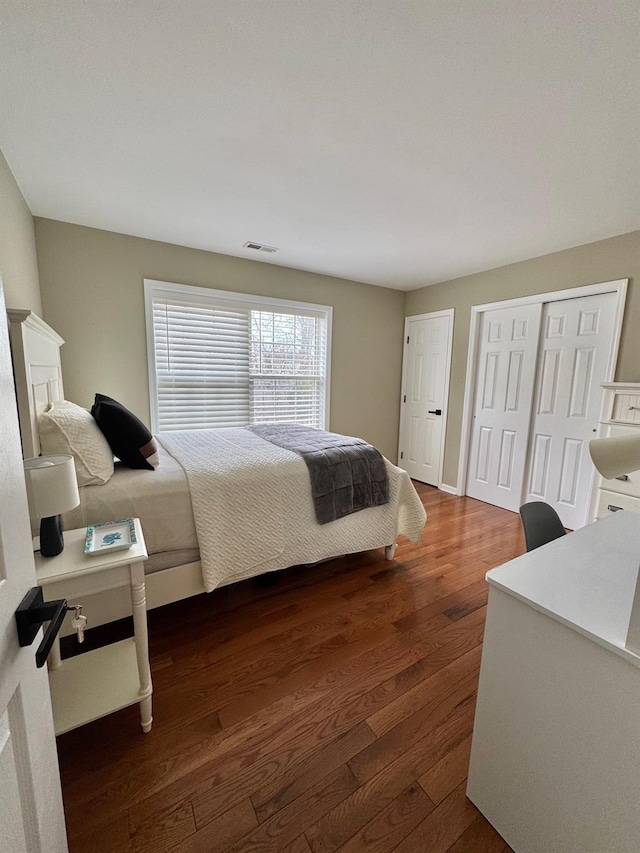 bedroom featuring dark wood-type flooring and visible vents
