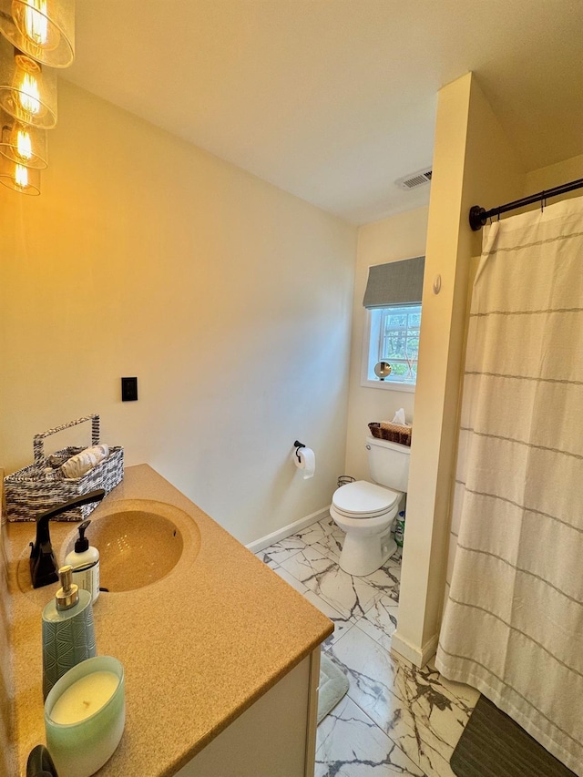 bathroom featuring toilet, visible vents, baseboards, marble finish floor, and vanity