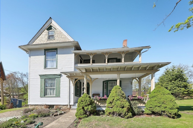 10 Wheeler Ave, Warwick, NY 10990 - view of front facade with a porch, central AC, a balcony, and a chimney