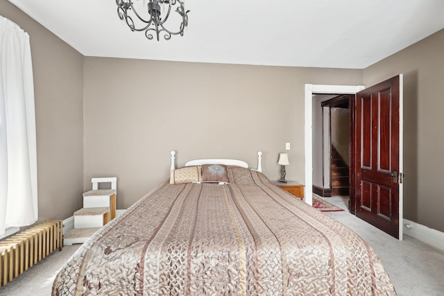 10 Wheeler Ave, Warwick, NY 10990 - bedroom with light colored carpet, radiator, and an inviting chandelier
