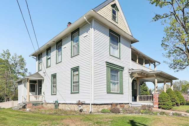 10 Wheeler Ave, Warwick, NY 10990 - view of side of property with a lawn, a chimney, a balcony, and a porch