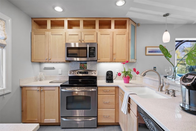 kitchen with tasteful backsplash, recessed lighting, light brown cabinetry, appliances with stainless steel finishes, and a sink