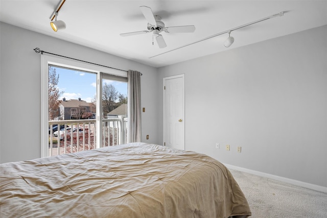 bedroom featuring track lighting, baseboards, access to outside, and carpet